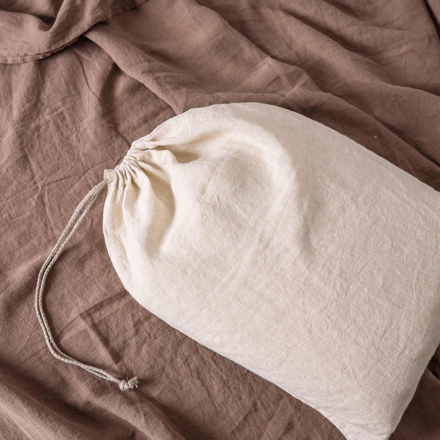 Close up of Lewisii linen laundry bag in sandy color. Duvet cover package.