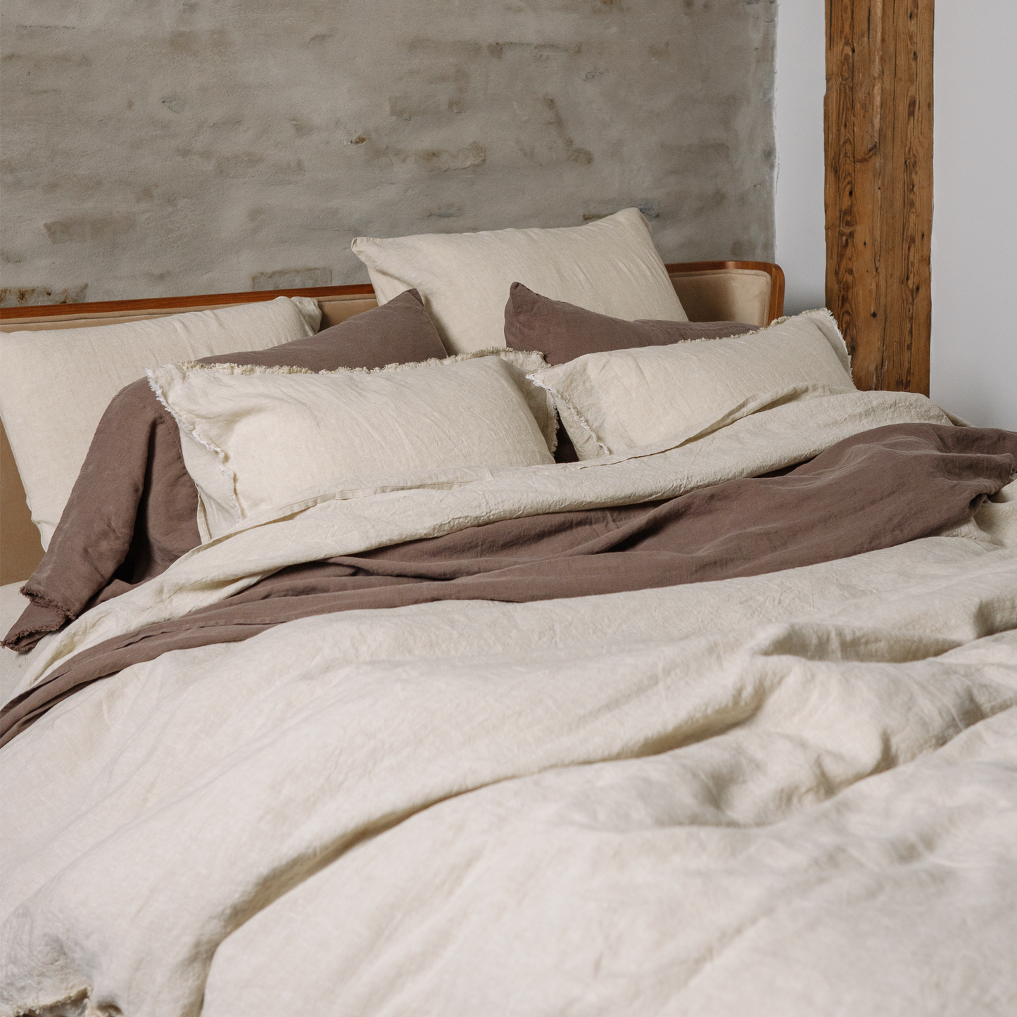Bed with LEWSII bedding and a couple of long linen pillowcases in color Cappuccino