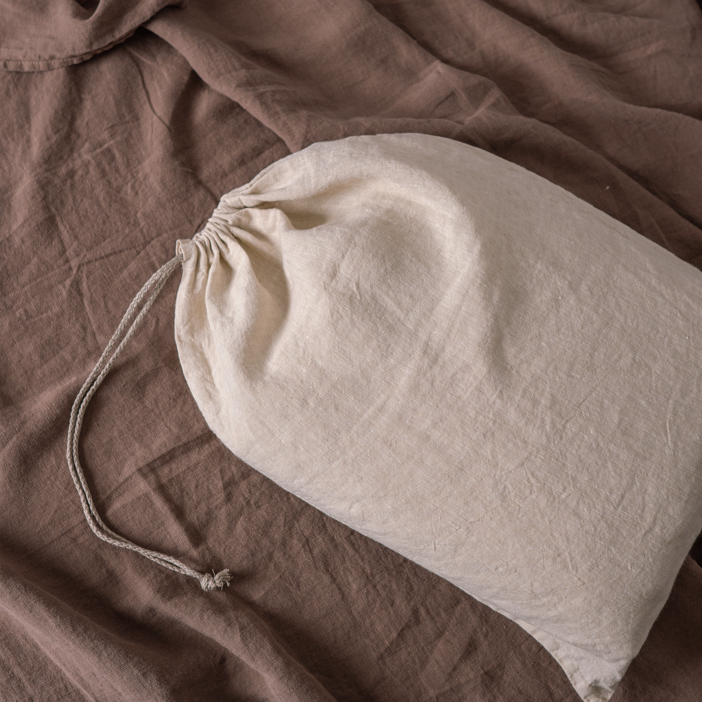 Close up of LEWISII linen laundry bag in sandy colour