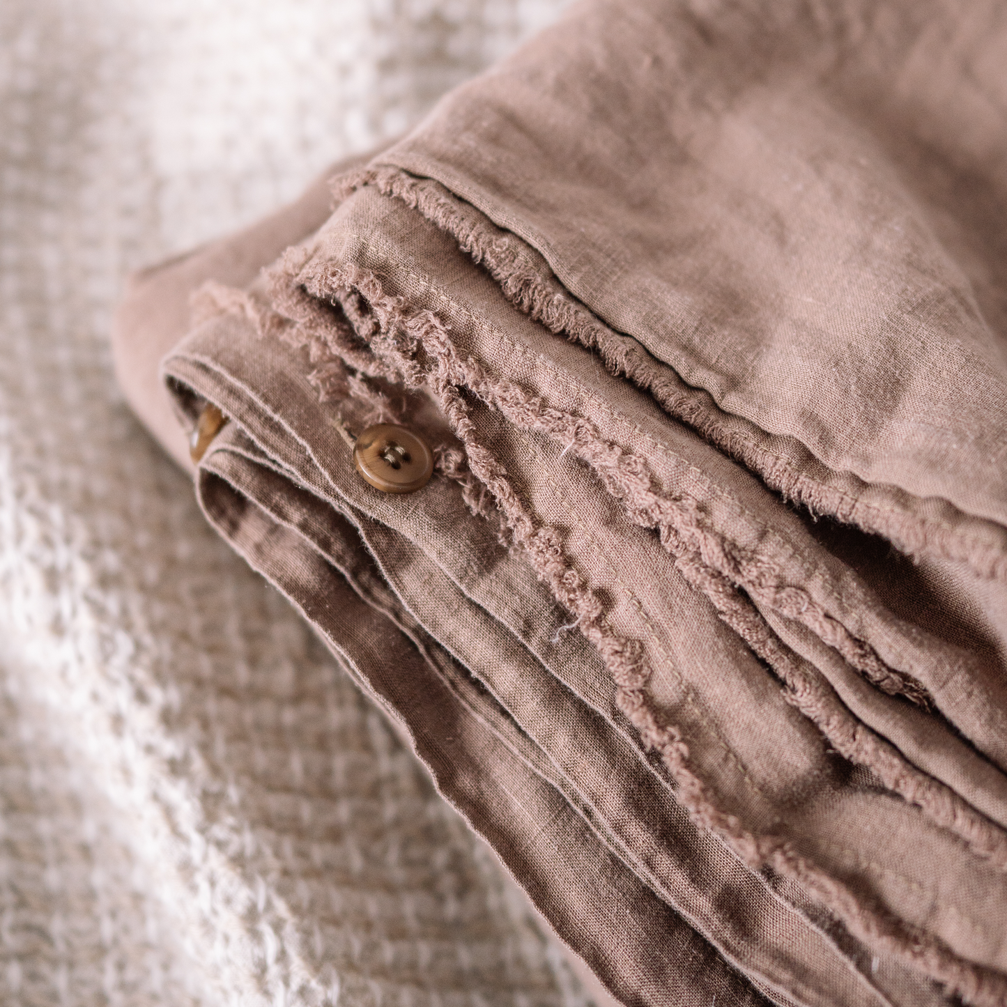 Cappuccino color Lewisii linen duvet cover  detail photo with buttons and fringe edges