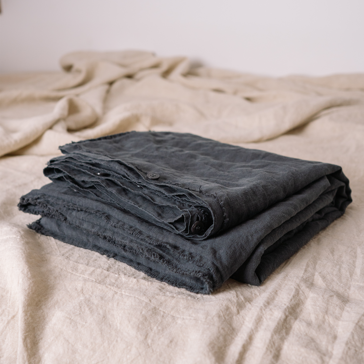 Dark Grey color Lewisii linen duvet detail photo with buttons and fringe edges 