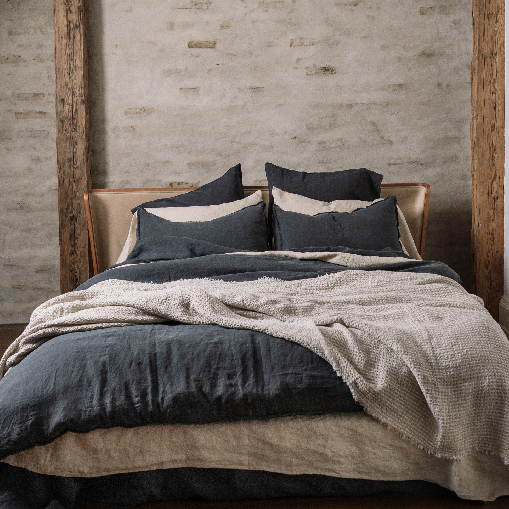 Bed covered in multiple pillows and sheets.