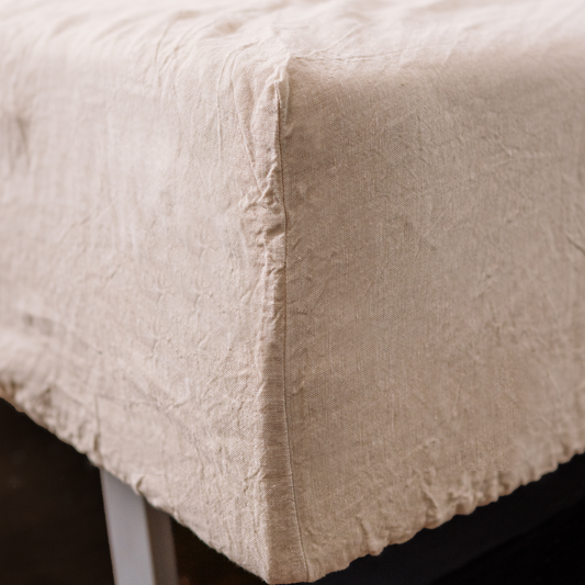 Sandy color fitted sheet close up photo with seam line