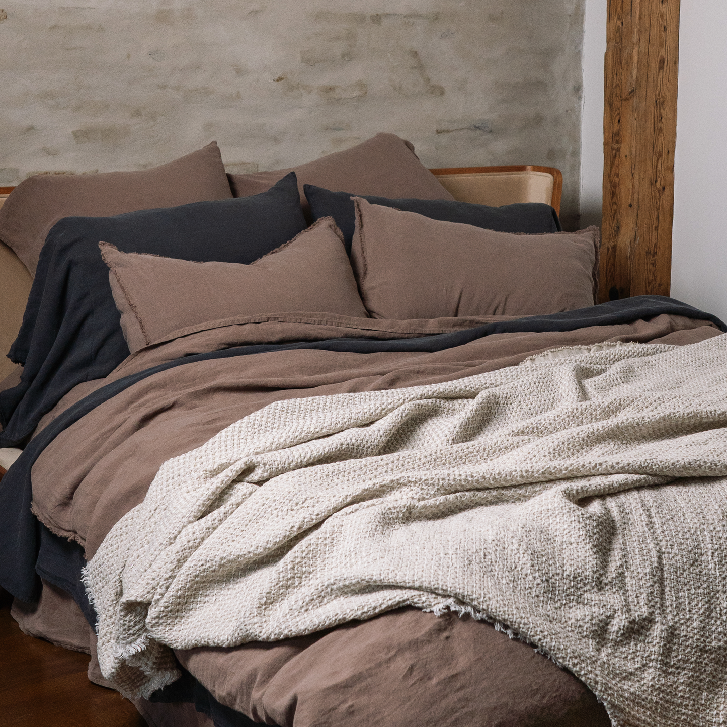 Basic linen LEWSII pillowcases in Cappuccino color on a bed with a white blanket